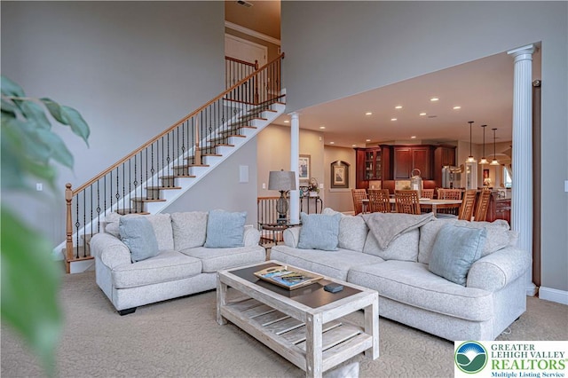 6532 Forest Knoll Ct, Upper Macungie Twp, PA 18106 - living room featuring decorative columns, light carpet, recessed lighting, stairway, and a high ceiling