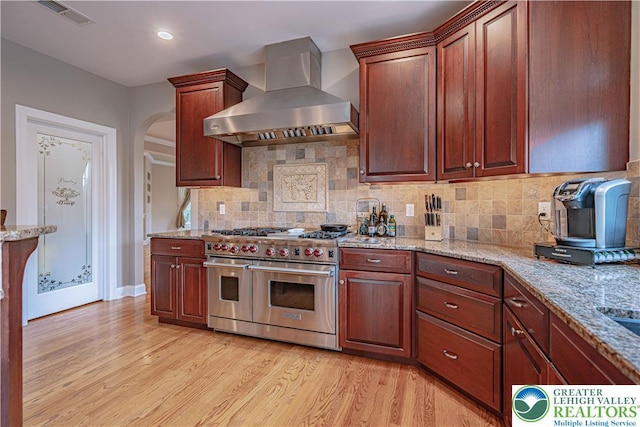 6532 Forest Knoll Ct, Upper Macungie Twp, PA 18106 - kitchen featuring double oven range, wall chimney range hood, light wood-style floors, light stone countertops, and recessed lighting