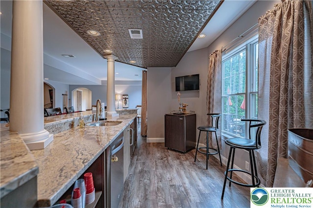 6532 Forest Knoll Ct, Upper Macungie Twp, PA 18106 - kitchen featuring ornate columns, wood finished floors, an ornate ceiling, stainless steel dishwasher, and light stone countertops