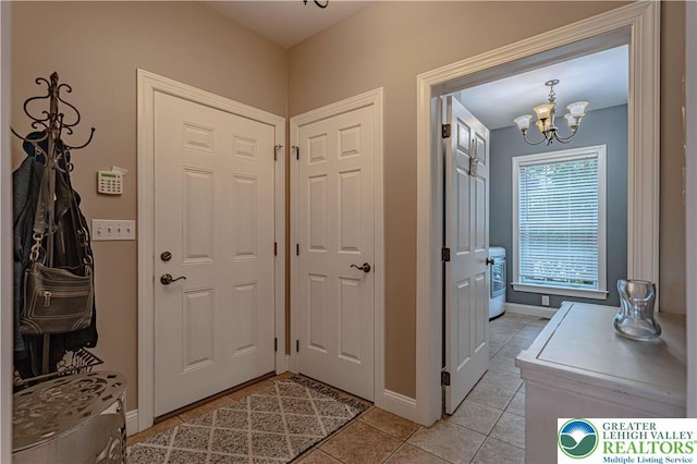 6532 Forest Knoll Ct, Upper Macungie Twp, PA 18106 - foyer entrance with light tile patterned floors, a chandelier, and washer / dryer