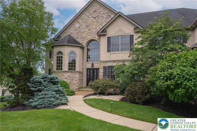 6532 Forest Knoll Ct, Upper Macungie Twp, PA 18106 - french country inspired facade with stone siding, stucco siding, and a front lawn