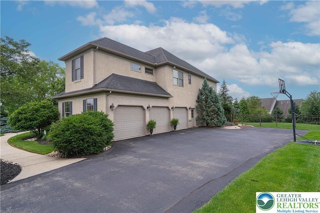 6532 Forest Knoll Ct, Upper Macungie Twp, PA 18106 - view of side of property with a garage, stucco siding, and driveway