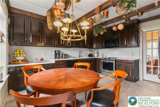 2730 Chew St, Allentown City, PA 18104 - kitchen with black appliances, light countertops, a chandelier, light tile patterned flooring, and dark brown cabinets