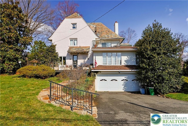 2730 Chew St, Allentown City, PA 18104 - view of front of property with stucco siding, a chimney, driveway, a garage, and a front yard