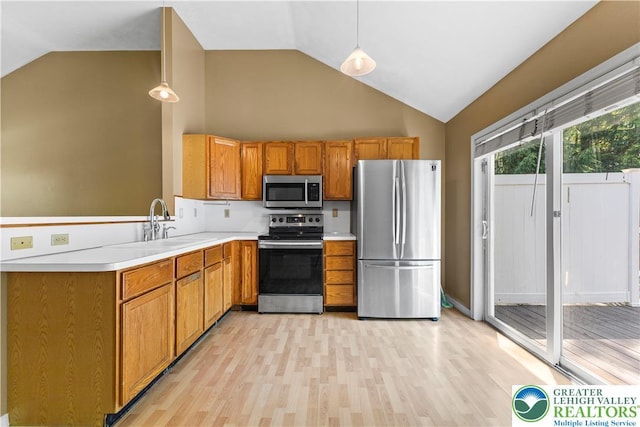 197 Broad Mountain View Dr, Penn Forest Twp, PA 18229 - kitchen with appliances with stainless steel finishes, light wood-style floors, light countertops, high vaulted ceiling, and brown cabinets