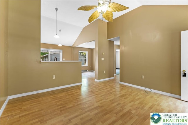 197 Broad Mountain View Dr, Penn Forest Twp, PA 18229 - unfurnished living room with vaulted ceiling, a ceiling fan, light wood-type flooring, and baseboard heating