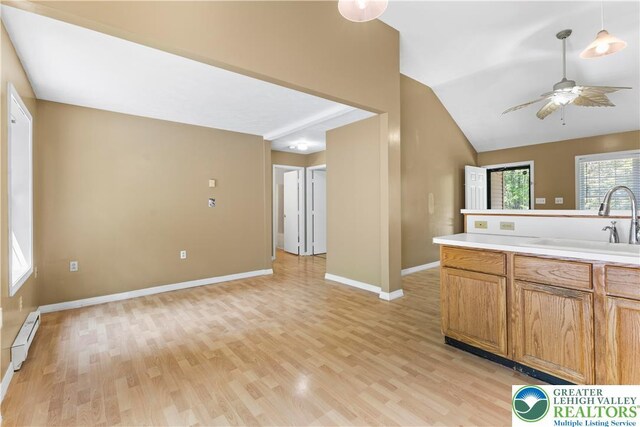 197 Broad Mountain View Dr, Penn Forest Twp, PA 18229 - kitchen featuring a ceiling fan, a baseboard radiator, light wood-style floors, light countertops, and brown cabinets