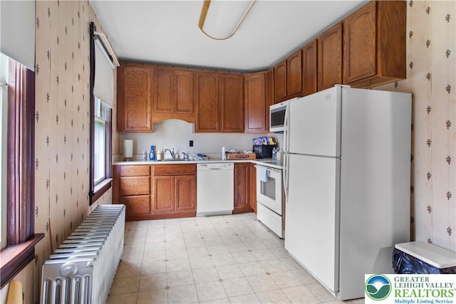 170 S Whitfield St, Nazareth Boro, PA 18064 - kitchen featuring white appliances, wallpapered walls, radiator, brown cabinets, and light countertops