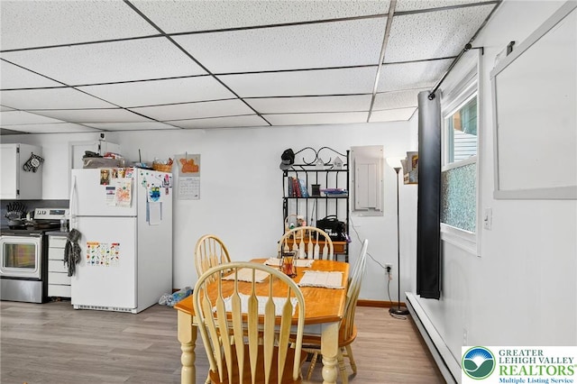 485 S Walnut St, Slatington Boro, PA 18080 - dining area featuring baseboard heating, light wood finished floors, and a paneled ceiling