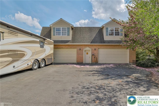 634 Country Club Rd, Easton, PA 18045 - view of property with asphalt driveway, a shingled roof, brick siding, and a garage