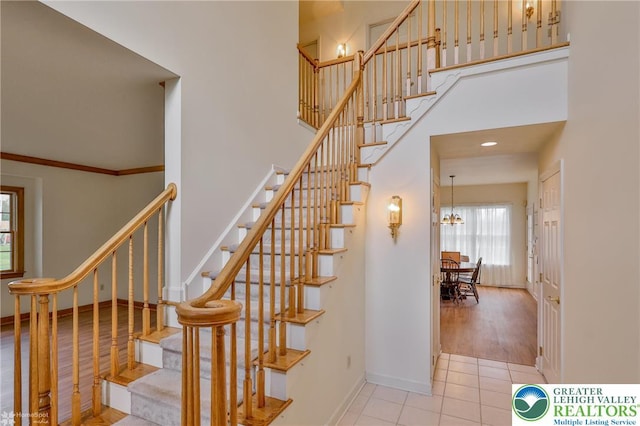 634 Country Club Rd, Easton, PA 18045 - staircase featuring a high ceiling, a chandelier, and tile patterned floors