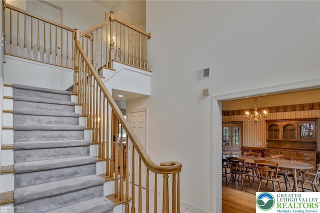 634 Country Club Rd, Easton, PA 18045 - stairs with a chandelier, a towering ceiling, and wood finished floors