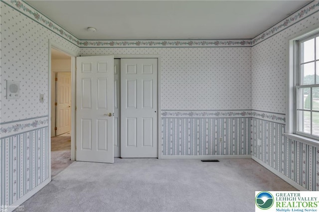 634 Country Club Rd, Easton, PA 18045 - unfurnished bedroom with wallpapered walls, carpet floors, multiple windows, and a closet