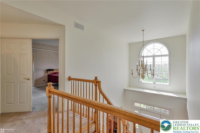 634 Country Club Rd, Easton, PA 18045 - hall featuring a chandelier, an upstairs landing, carpet flooring, and plenty of natural light