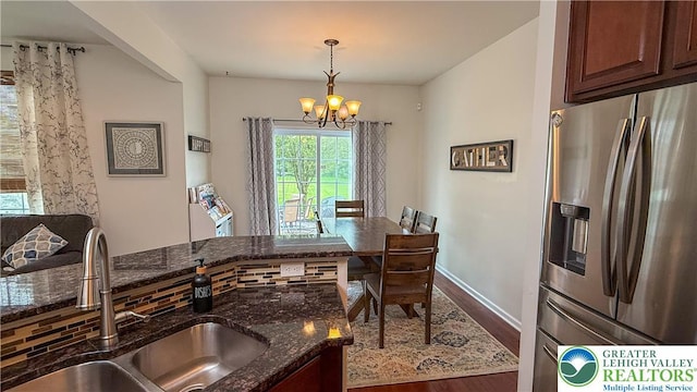 102 Gray Dr, Allen Twp, PA 18067 - kitchen featuring stainless steel refrigerator with ice dispenser, a chandelier, wood finished floors, dark stone counters, and pendant lighting