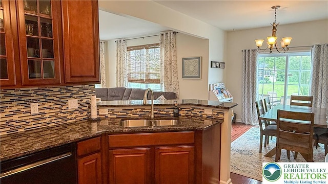 102 Gray Dr, Allen Twp, PA 18067 - kitchen with dishwashing machine, a peninsula, dark stone counters, a chandelier, and wood finished floors