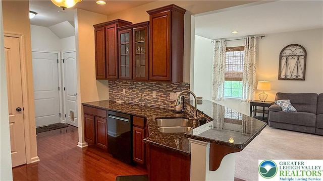 102 Gray Dr, Allen Twp, PA 18067 - kitchen with dishwashing machine, a peninsula, dark wood-style flooring, glass insert cabinets, and tasteful backsplash