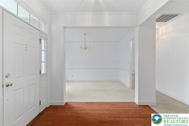 1883 Gregory Pl, Lower Saucon Twp, PA 18055 - entrance foyer featuring a chandelier, carpet, and crown molding