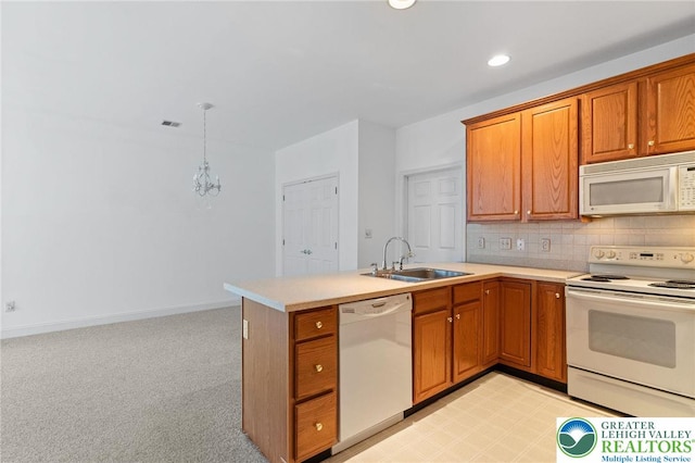 1883 Gregory Pl, Lower Saucon Twp, PA 18055 - kitchen featuring white appliances, a peninsula, brown cabinets, light countertops, and backsplash