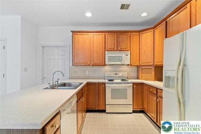 1883 Gregory Pl, Lower Saucon Twp, PA 18055 - kitchen with white appliances, a peninsula, decorative backsplash, light countertops, and recessed lighting