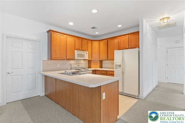 1883 Gregory Pl, Lower Saucon Twp, PA 18055 - kitchen featuring white appliances, a peninsula, light countertops, recessed lighting, and brown cabinets