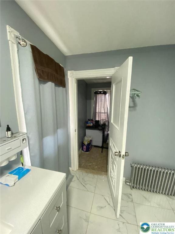 522 N Jordan St, Allentown City, PA 18102 - bathroom featuring radiator, marble look tiles, and vanity