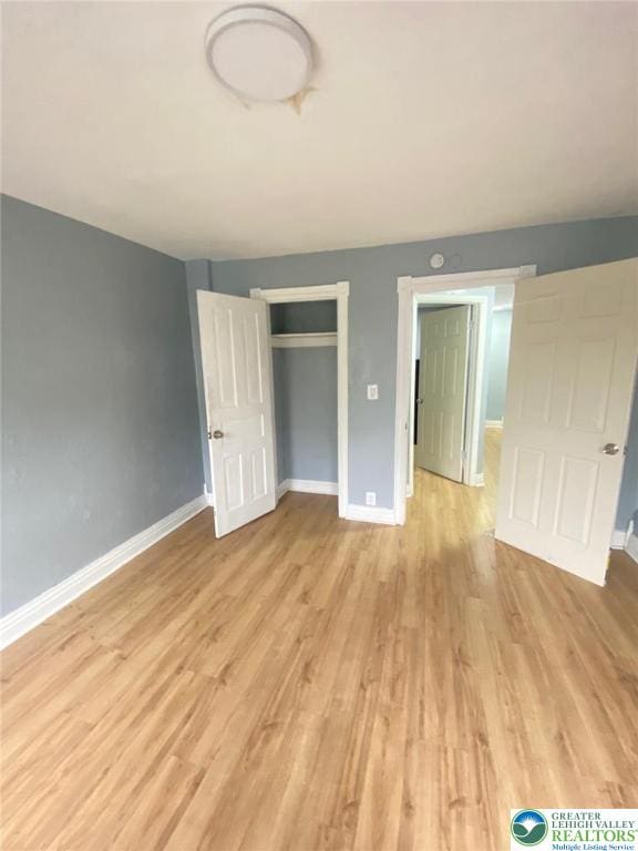 522 N Jordan St, Allentown City, PA 18102 - unfurnished bedroom with light wood-style flooring and a closet