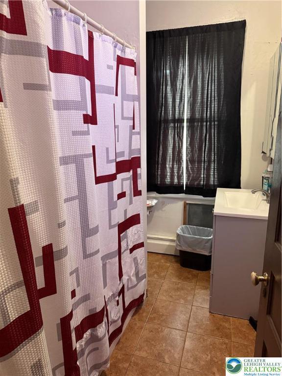713 E 5th St, Bethlehem City, PA 18015 - full bathroom featuring vanity, tile patterned flooring, a baseboard radiator, and a shower with curtain