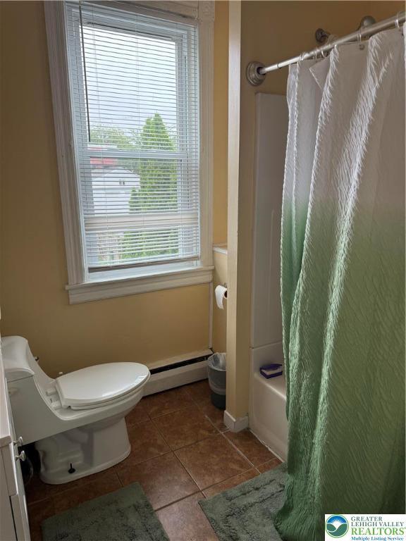 713 E 5th St, Bethlehem City, PA 18015 - bathroom featuring a baseboard heating unit, tile patterned floors, and shower / tub combo