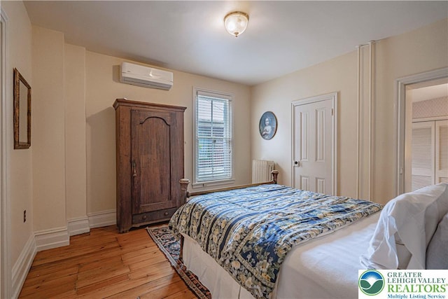 407 N 8th St, Allentown City, PA 18102 - bedroom featuring a wall unit AC, radiator, and light wood-type flooring