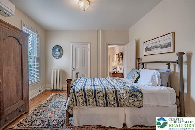 407 N 8th St, Allentown City, PA 18102 - bedroom featuring radiator, a wall mounted AC, and light wood-style floors