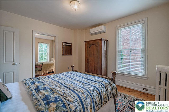 407 N 8th St, Allentown City, PA 18102 - bedroom featuring an AC wall unit, radiator, and wood finished floors