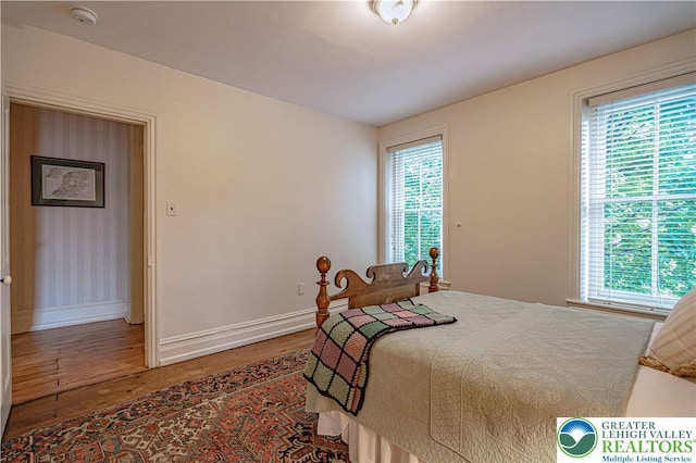 407 N 8th St, Allentown City, PA 18102 - bedroom featuring wood finished floors and multiple windows