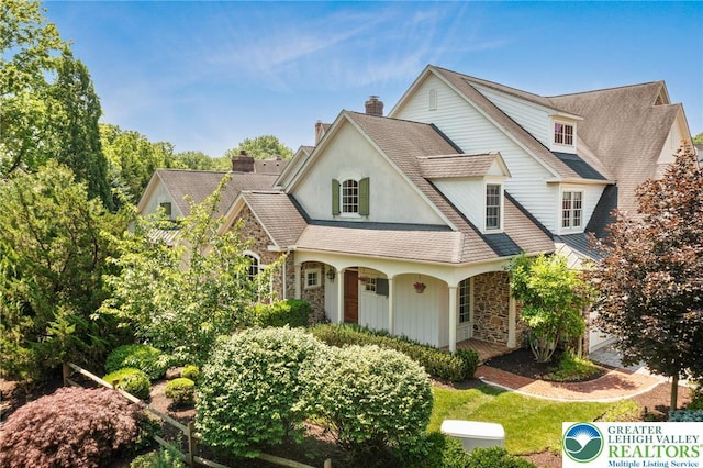 2051 Forge Run, Bethlehem City, PA 18015 - view of front of home featuring stone siding, covered porch, a chimney, and a shingled roof