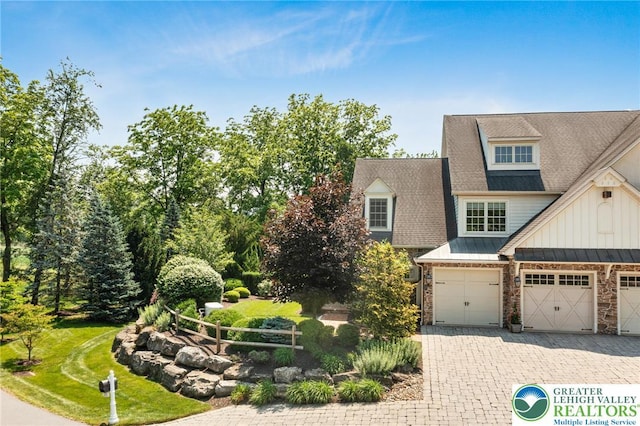 2051 Forge Run, Bethlehem City, PA 18015 - view of front of property featuring a standing seam roof, stone siding, board and batten siding, decorative driveway, and a metal roof