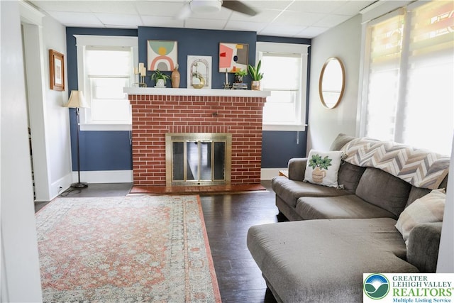 5242 3rd St, Whitehall Twp, PA 18052 - living area with a drop ceiling, a brick fireplace, healthy amount of natural light, and wood finished floors