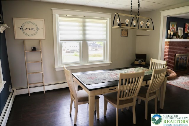 5242 3rd St, Whitehall Twp, PA 18052 - dining room with a fireplace, dark wood-style floors, a baseboard heating unit, and a drop ceiling