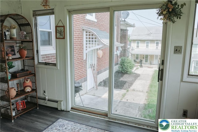 5242 3rd St, Whitehall Twp, PA 18052 - doorway featuring a baseboard heating unit and wood finished floors