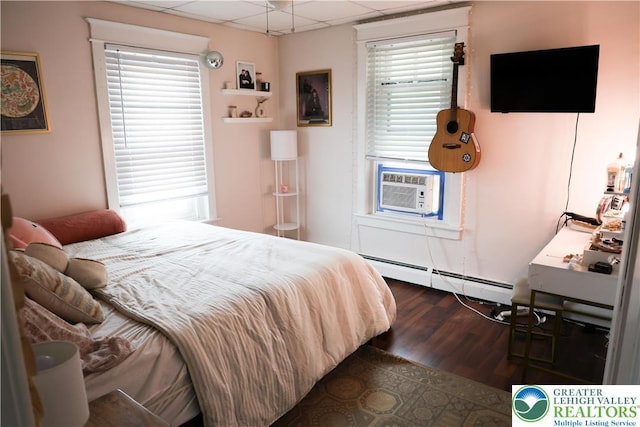 5242 3rd St, Whitehall Twp, PA 18052 - bedroom featuring a drop ceiling, a baseboard radiator, multiple windows, cooling unit, and dark wood-style floors