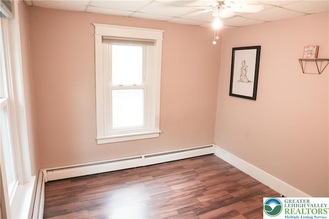 5242 3rd St, Whitehall Twp, PA 18052 - empty room featuring a baseboard radiator, a drop ceiling, wood finished floors, and a ceiling fan