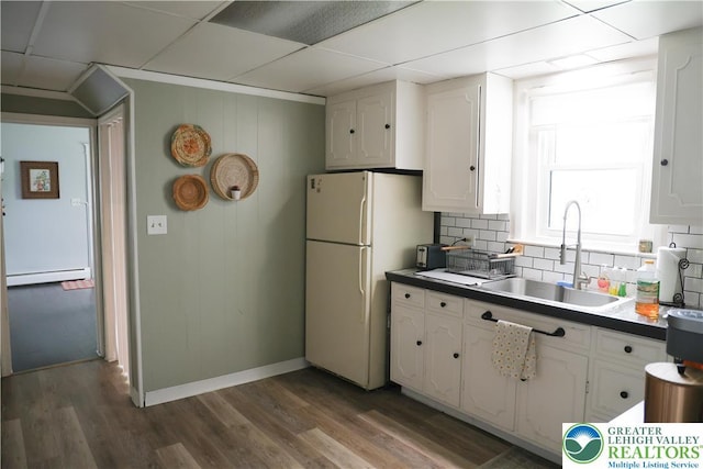 5242 3rd St, Whitehall Twp, PA 18052 - kitchen featuring freestanding refrigerator, a baseboard heating unit, white cabinets, wood finished floors, and a drop ceiling