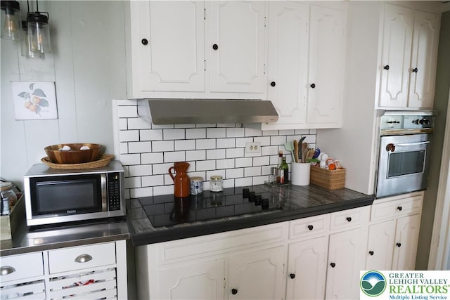 5242 3rd St, Whitehall Twp, PA 18052 - kitchen featuring appliances with stainless steel finishes, range hood, white cabinetry, and decorative backsplash