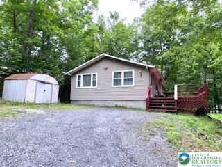 3641 Sequoia Dr, Middle Smithfield Twp, PA 18302 - view of front of home with a shed, a wooden deck, and gravel driveway