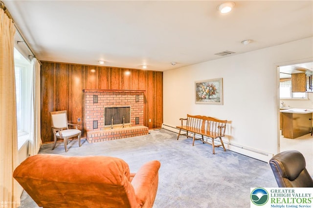 3609 Erie St, Palmer Twp, PA 18045 - living area with a baseboard heating unit, wood walls, healthy amount of natural light, a fireplace, and light colored carpet