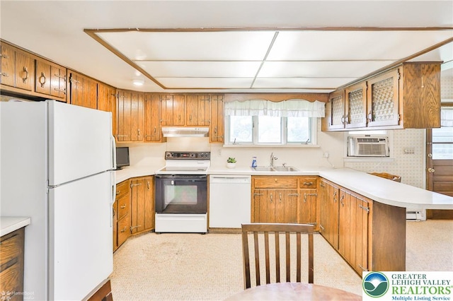 3609 Erie St, Palmer Twp, PA 18045 - kitchen with white appliances, under cabinet range hood, brown cabinets, a peninsula, and light colored carpet