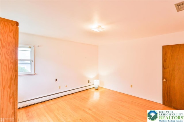 3609 Erie St, Palmer Twp, PA 18045 - empty room featuring a baseboard heating unit and wood finished floors