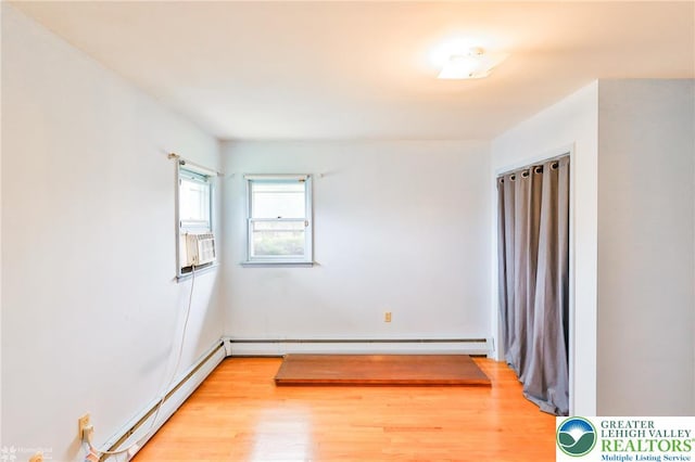 3609 Erie St, Palmer Twp, PA 18045 - empty room featuring a baseboard heating unit, light wood finished floors, baseboard heating, and cooling unit