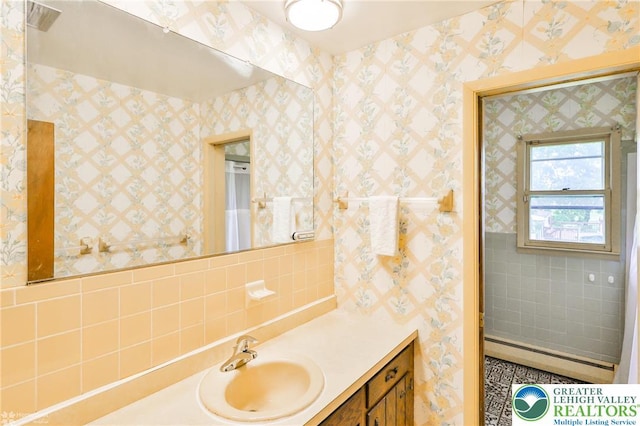 3609 Erie St, Palmer Twp, PA 18045 - bathroom with vanity, baseboard heating, decorative backsplash, and tile walls