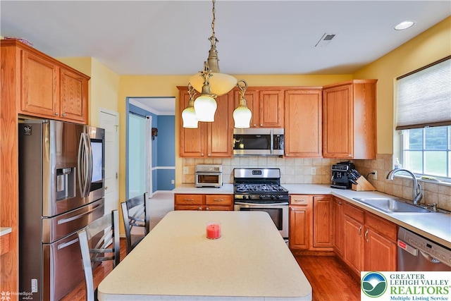10 Windrift Ct, Easton, PA 18045 - kitchen featuring appliances with stainless steel finishes, wood finished floors, light countertops, tasteful backsplash, and recessed lighting