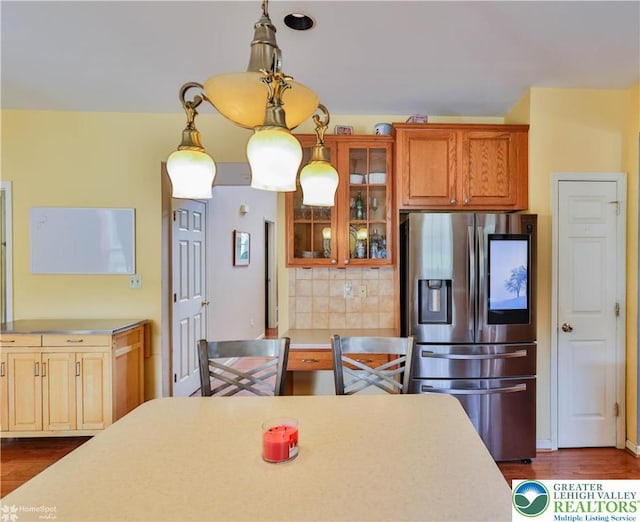 10 Windrift Ct, Easton, PA 18045 - kitchen featuring stainless steel fridge with ice dispenser, light countertops, backsplash, glass insert cabinets, and dark wood-type flooring